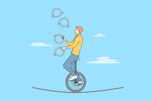 Perfomance, sport, art, acrobatics, air concept. Young professional man guy boy acrobat athlete juggler gymnast character with clubs riding unicycle on rope in circus. Active entertainment for people.