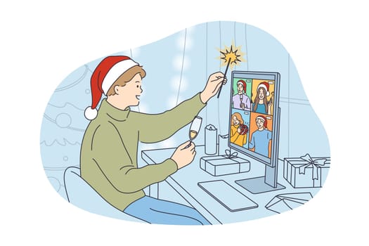 Online New Year and Christmas celebration concept. Young happy man in festive hat drinking champagne holding sparkler and chatting with friends online on laptop virtual video celebrating holiday