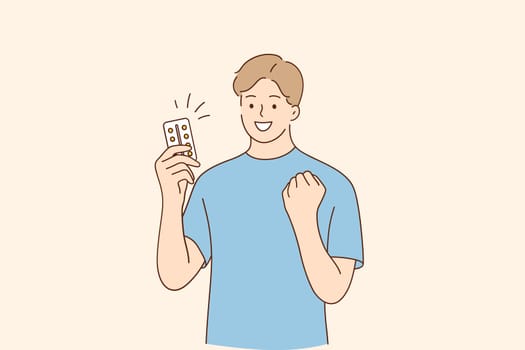 Medicine, healthcare, drugs concept. Young smiling man cartoon character standing holding medicine pills feeling proud, celebrating victory and success vector illustration
