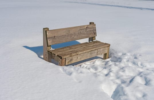 Wooden Bench in Winter Snow in Crabtree Nature Center in Illinois