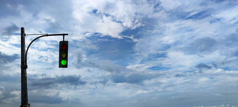 The traffic lights against a vibrant blue sky