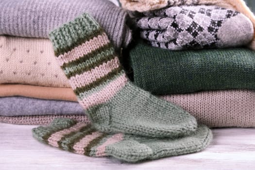 Knitting clothes on wooden background
