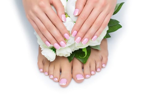 Beautiful woman hands and feet with french manicure resting near peony flowers. Isolated over white background. Copy space.
