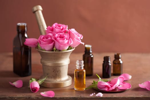 spa and aromatherapy set with rose flowers mortar essential oils