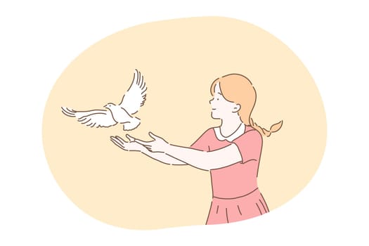 Freedom, peace, harmony, release, kindness concept. Young kind smiling girl cartoon character in dress standing and letting white pigeon dove bird fly from hands in park outdoor releasing letting go