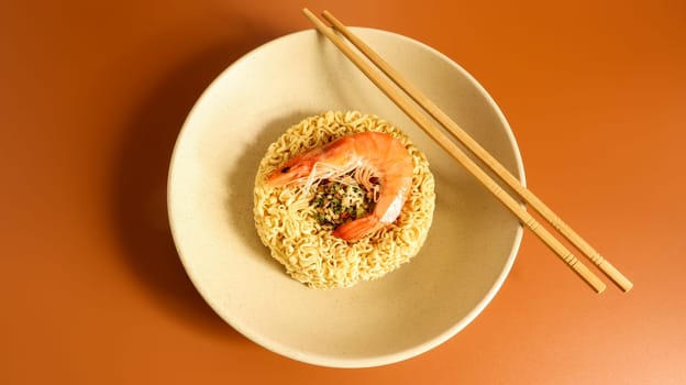 Spicy instant noodle soup with shrimp. shrimp soup, cooking, food. Raw dried circle-shaped vermicelli in a plate. Asian food. pasta, for the preparation of which it is enough to pour boiling water.