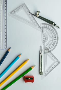 Geometric Measuring tools, Drawing items and mathematical instruments placed on white paper sheet. Back to school and Engineering education learning background. Empty Copy space room for text.