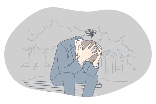 Sadness, mental depression, bad news concept. Young unhappy man sitting on bench with head in hands feeling depressed with thoughts after negative events, crying, suffering from loneliness