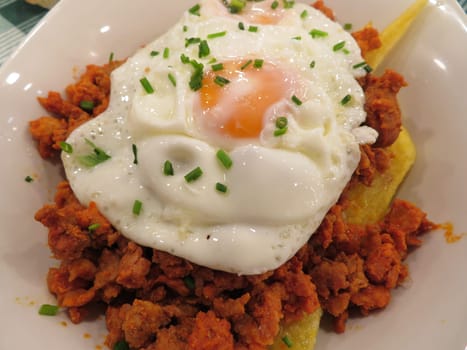 delicious fried eggs with mincemeat meat chips