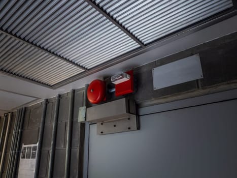 Electric red fire ring bell alarm on the wall in system room