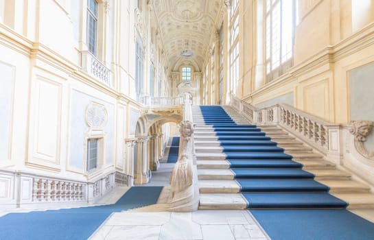 TURIN, ITALY - CIRCA JUNE 2021: The most beautiful Baroque staircase of Europe located in Madama Palace (Palazzo Madama). Interior with luxury marbles, windows and corridors.