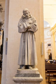 Assisi village in Umbria region, Italy. Statue of St. Francis. The town is famous for the most important Italian St. Francis Basilica (Basilica di San Francesco)