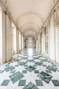 VENARIA REALE, ITALY - CIRCA MAY 2021: corridor with floor made of luxury marbles. Plenty of elegance for this Italian interior in Venaria Reale, Piedmont region.
