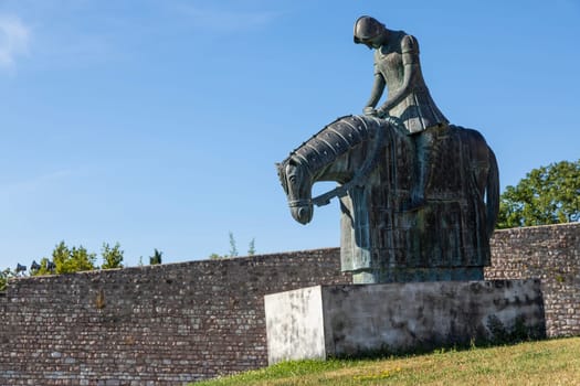 Assisi village in Umbria region, Italy. Statue of St. Francis. The town is famous for the most important Italian St. Francis Basilica (Basilica di San Francesco)