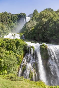 Marmore waterfall in Umbria region, Italy. Amazing cascade splashing into nature with trees and rocks.