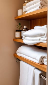 Spa treatment set, wooden shelf with neatly folded towels and dispensers for soap, cream, massage oil. High quality photo