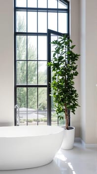 Scandinavian style bathroom interior in light colors. The bathtub is located near the window. High quality photo