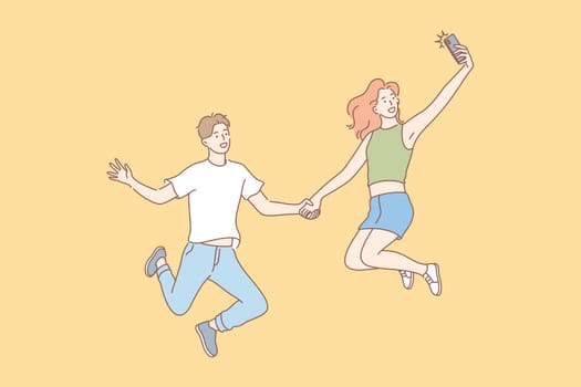 Jumping people, selfie, couple, leisure concept. Jumping people, man and woman, boyfriend girlfriend or teenagers, couple in love, taking selfie on smartphone for social media. Modern lifestyle.