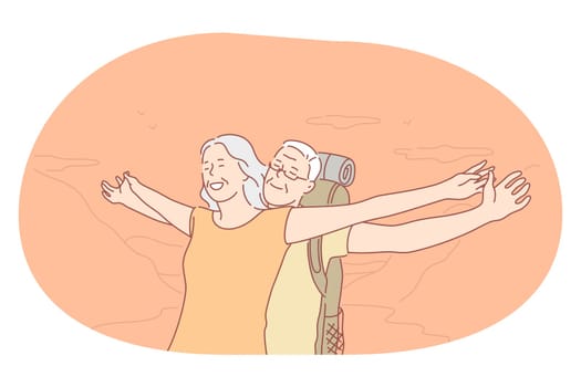 Senior elderly couple living happy active lifestyle concept. Happy mature loving couple pensioners woman and man traveling with backpack and standing with hands stretched enjoying journey
