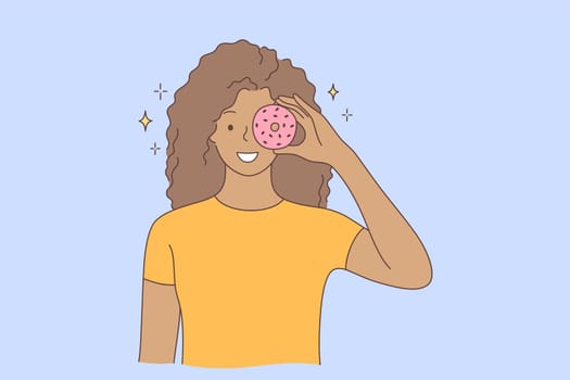 Food, beauty, junk food, advertising, fun concept. Young happy smiling cheerful african american woman girl character holding doughnut on eye. Having fun with sweets and unhealthy nutrition promotion.