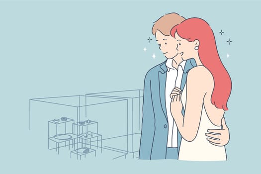 Couple, shopping, beauty, fashion, choice concept. Youn man woman husand wife boyfriend girlfriend characters standing in jewellery shop and choosing gift wedding ring together. Fashionable lifestyle.