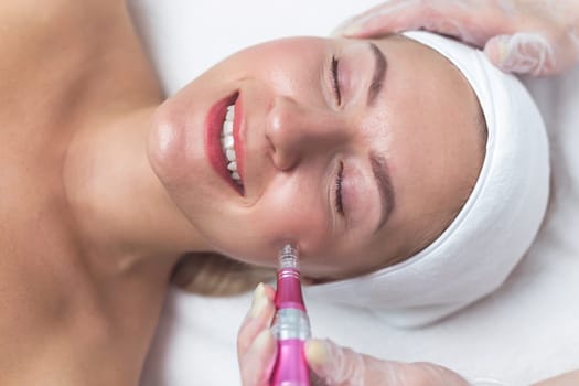 Woman having facial treatment in beauty salon, closeup. Oxy derma therapy with derma pen