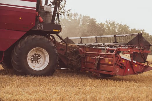 Combine harvester in the field. Close-up of a reel. Harvesting season. Rye and barley.