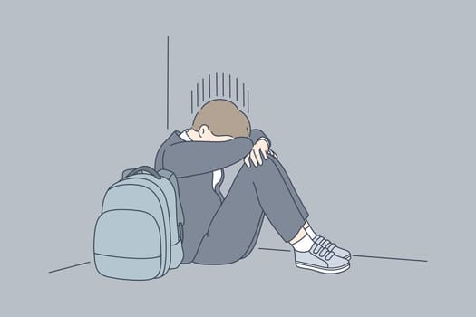 Despair, frustration, depression, mental stress, bullying concept. Young desperate frustrated depressed child schoolboy sitting in corner crying. Negative emotions headache or migraine and bad news.