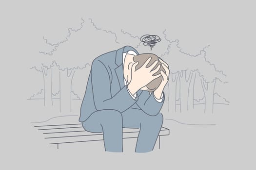Despair, frustration, depression, business concept. Desperate young businessman crying in his hands sitting on bench covering head. Fatigue headache or migraine bad news and raising of mental stress.