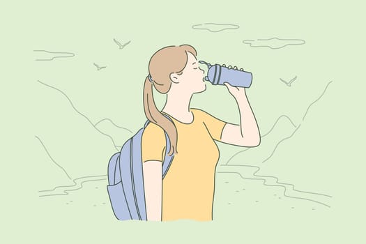 Travelling, tourism, nature, hiking concept. Young thirsty woman hiker tourist with backpack standing in mountain valley and drinking water. Vacation trip with active recreation and extreme lifestyle.