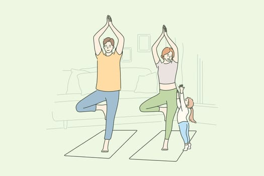 Family, yoga, sport, recreation concept. Man dad and woman mom do morning yoga practice exercise at home while child kid daughter seeking attention. Active lifestyle healthcare or fathers mothers day.