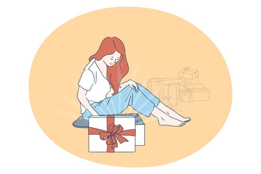 Birthday or Christmas present, New year, holiday concept. Young woman sitting on floor between birthday gifts in boxes with festive ribbons. Surprise, anniversary, gift, happiness