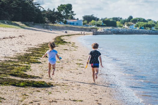 Children running on La Phibie beach on the island of Oléron in France