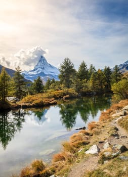 Famous alpine peak Matterhorn refleced in a pond in Swiss Apls