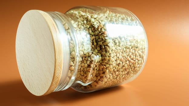 Green sprouts of raw organic buckwheat in a glass jar for cereals. Vegan food concept. Organic food. The concept of diet, weight loss, healthy and proper nutrition. Copy space for text