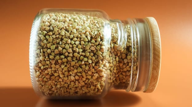 Green sprouts of raw organic buckwheat in a glass jar for cereals. Vegan food concept. Organic food. The concept of diet, weight loss, healthy and proper nutrition. Copy space for text