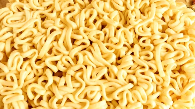 Close Up texture of instant noodles. pasta, for the preparation of which it is enough to pour boiling water and wait a few minutes. Fragrances are also commonly added to add flavor