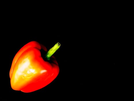 Vegetable red bell pepper on a black background. Food photo. Template for text. The menu of dishes. Place for text. Background image.