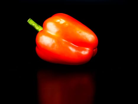 Vegetable red bell pepper on a black background. Food photo. Template for text. The menu of dishes. Place for text. Background image.