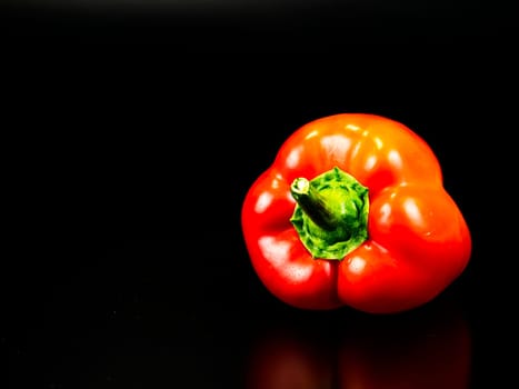 Vegetable red bell pepper on a black background. Food photo. Template for text. The menu of dishes. Place for text. Background image.