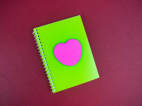 Notebook for notes with a heart symbol. Valentine's Day. Mothers Day. Happy Birthday. Place for text. Writing pen.