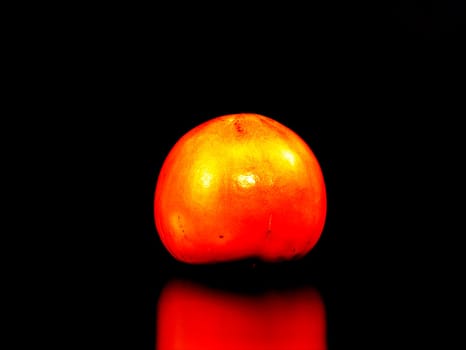 Persimmon fruit on a black background. Food photo. Place for text.