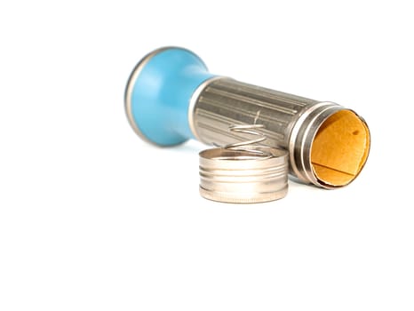 Pocket flashlight in a metal case on a white background. Retro. Technology. Place for text. Background image.