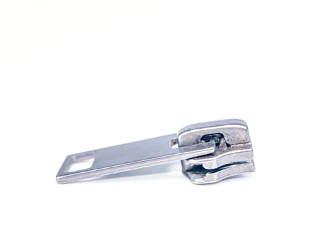 Zipper slider on a white background. Place for text. Free place. Macro photo.