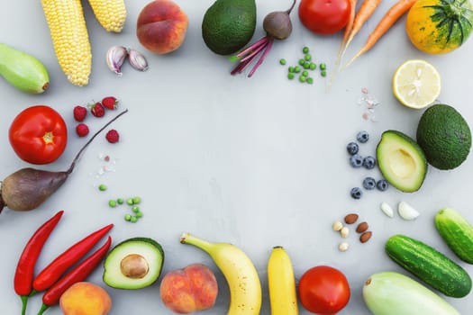 Flat lay with different food, organic vegetables, bio fruits, berries, nuts, spices, herbs. Copy space area for some text. Veggies on grey concrete background. Organic bio food healthy eating concept