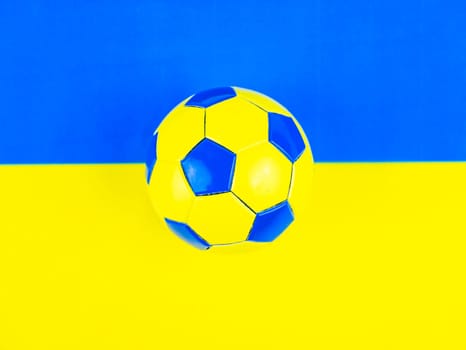 Soccer ball on the background of the national flag of Ukraine. Place for text. Football championship. Europe. World. National team.
