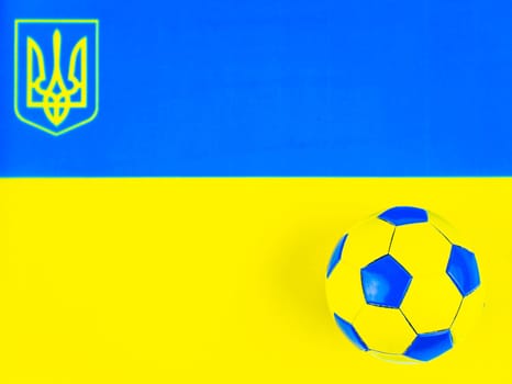 Soccer ball on the background of the national flag of Ukraine. Place for text. Football championship. Europe. World. National team.