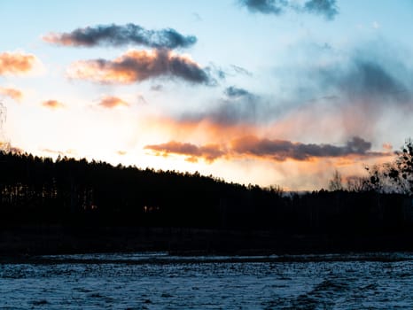 Sunset in the clouds over the forest horizon. Nature. Scenery. Background image.