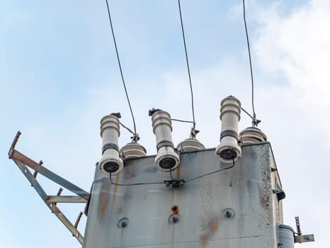 High-voltage power line transformer with wires. Technology. Industry. Place for text. Background image.