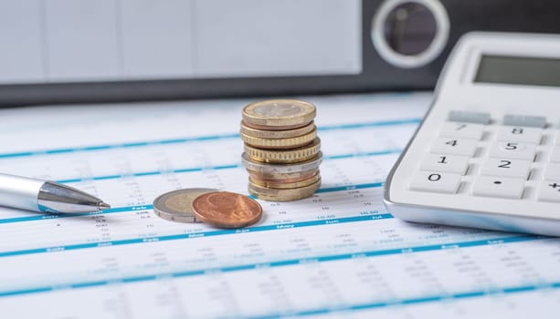 Coins on documents with a calculator